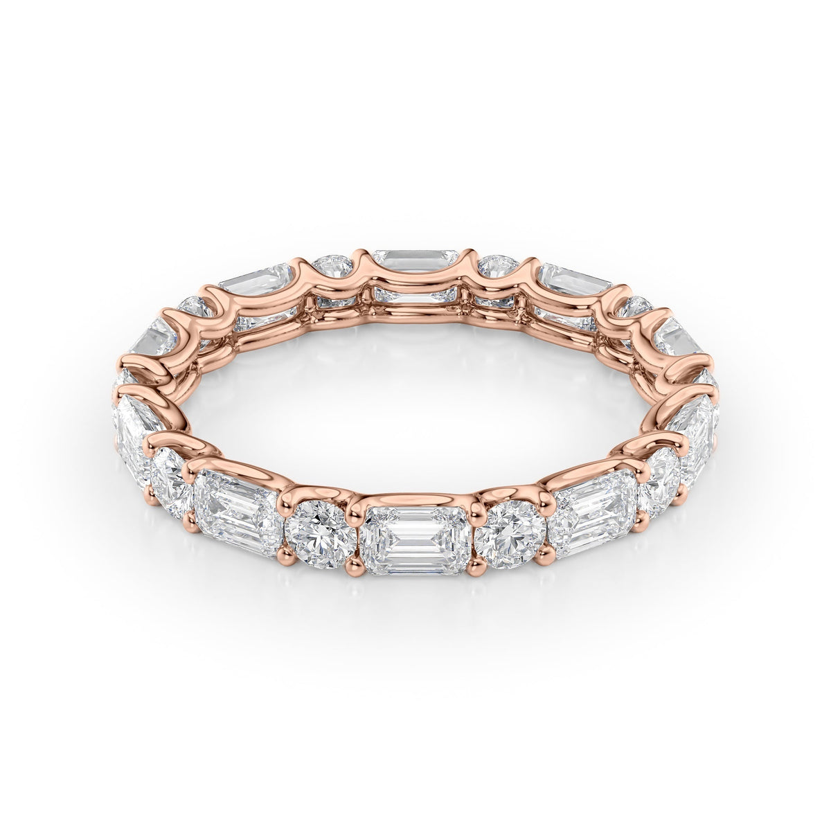 2.6ct Alternating Emerald And Round U Prong Eternity. A Rose Gold Eternity Ring Set With 2tcw Emerald Lab Grown Diamonds. White Background.