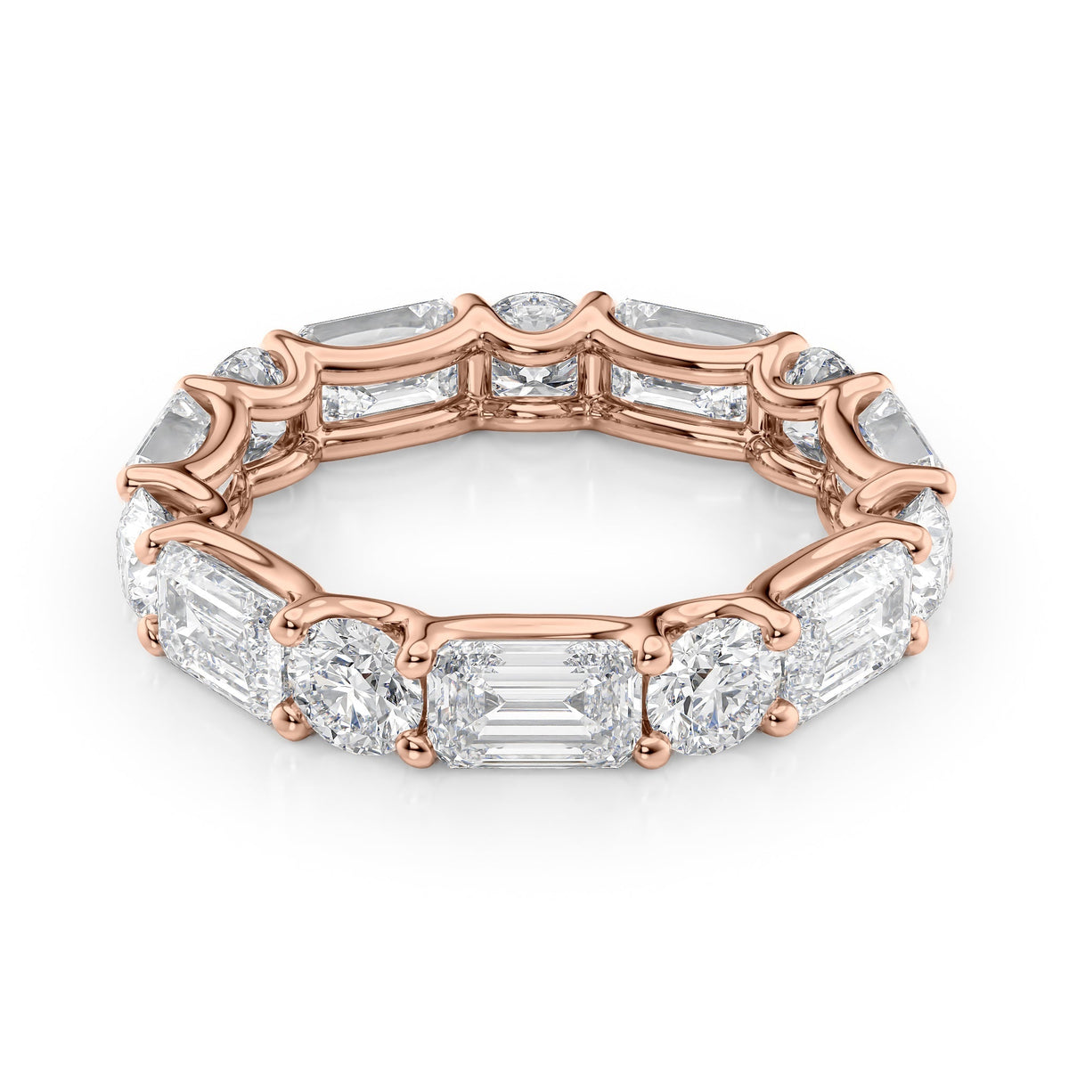 5ct Alternating Emerald And Round U Prong Eternity. A Rose Gold Eternity Ring Set With 3.5tcw Emerald Lab Grown Diamonds. White Background.