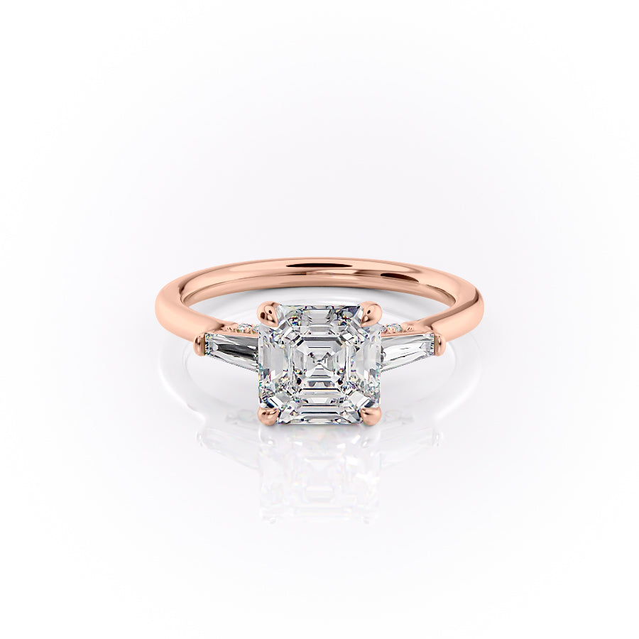 The Baguettes Megan. A Rose Gold Three Stone Engagement Ring Set With A 2ct Asscher Lab Grown Diamond. White Background.