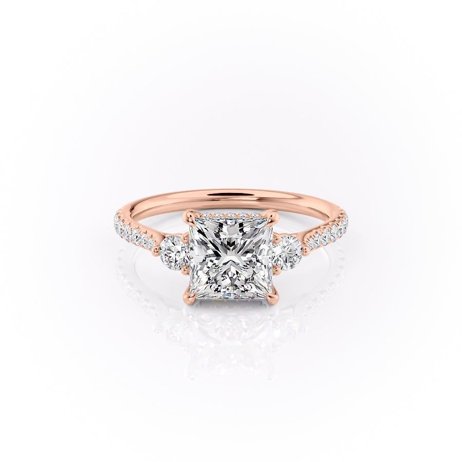 The Pave Lia. A Rose Gold Three Stone Engagement Ring Set With A 2ct Princess Lab Grown Diamond. White Background.