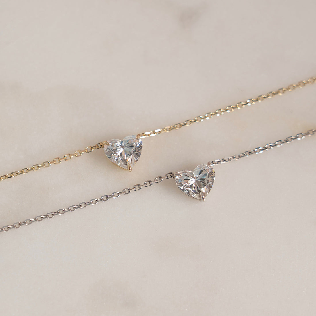 Heart diamond pendants in white and yellow gold