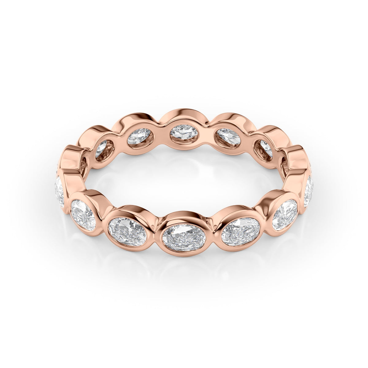 1.4ct East West Oval Bezel Eternity. A Rose Gold Eternity Ring Set With 1.4tcw Oval Lab Grown Diamonds. White Background.