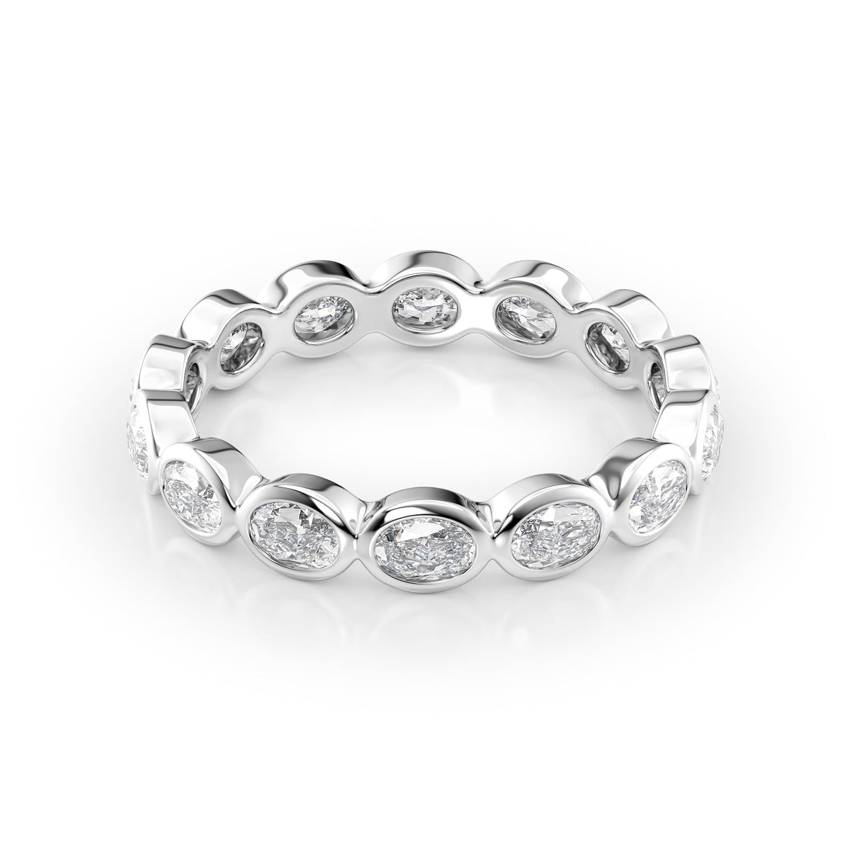 1.4ct East West Oval Bezel Eternity. A White Gold Eternity Ring Set With 1.4tcw Oval Lab Grown Diamonds. White Background.