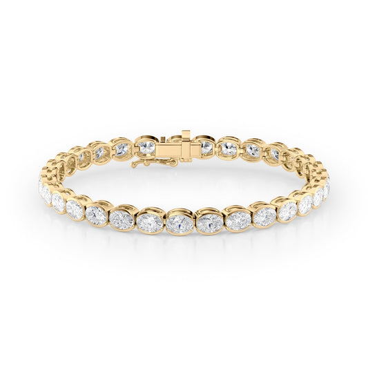 11.5ct East West Half Bezel Oval Tennis Bracelet. A Yellow Gold Tennis Bracelet Set With 11.5tcw Oval Lab Grown Diamonds. White Background.
