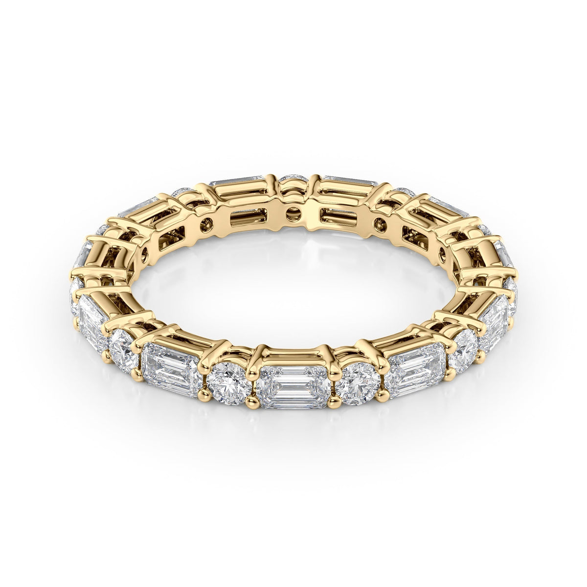 2.1ct Alternating Emerald And Round Basket Eternity. A Yellow Gold Eternity Ring Set With 1.6tcw Emerald Lab Grown Diamonds. White Background.