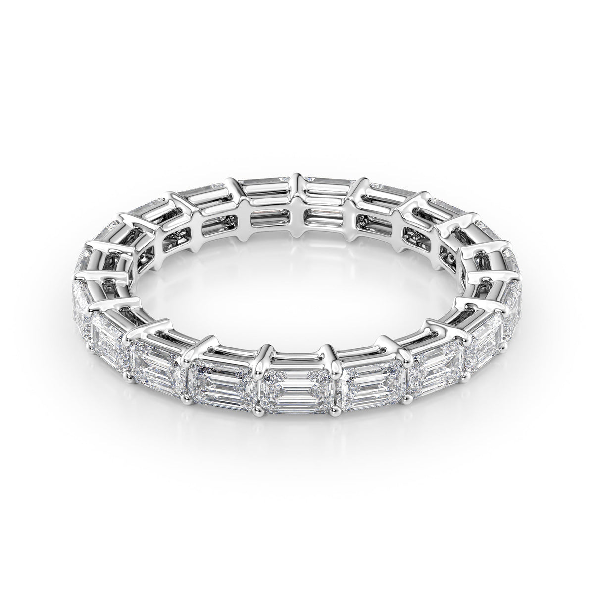 2.5ct East West Emerald Eternity. A White Gold Eternity Ring Set With 2.5tcw Emerald Lab Grown Diamonds. White Background.