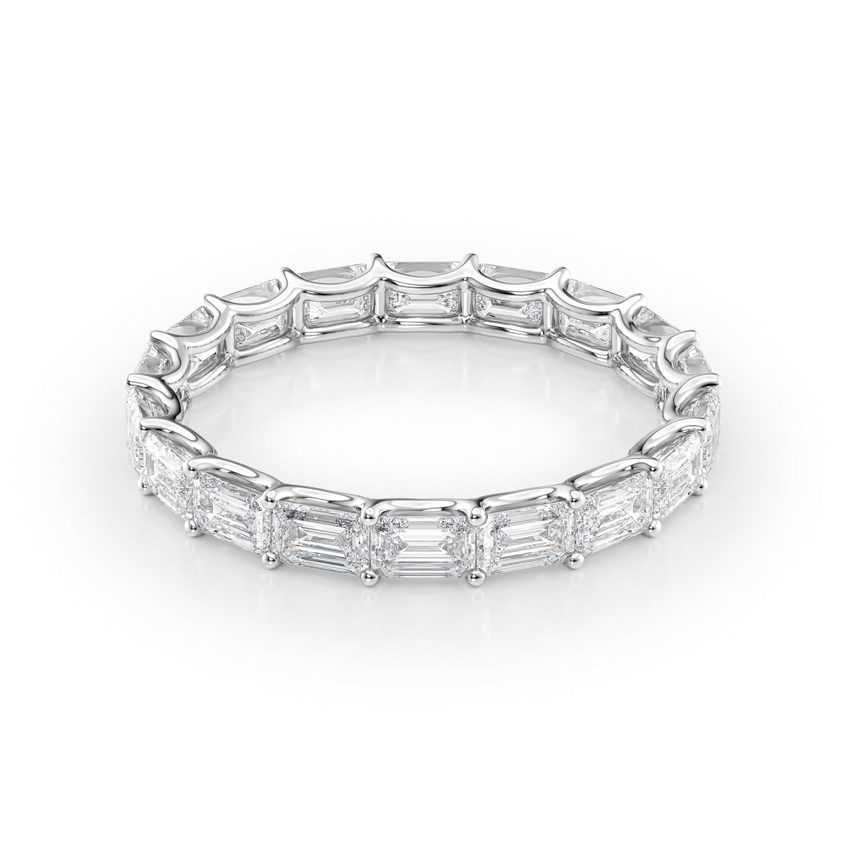 2.5ct East West Emerald U Prong Eternity. A White Gold Eternity Ring Set With 2.5tcw Emerald Lab Grown Diamonds. White Background.