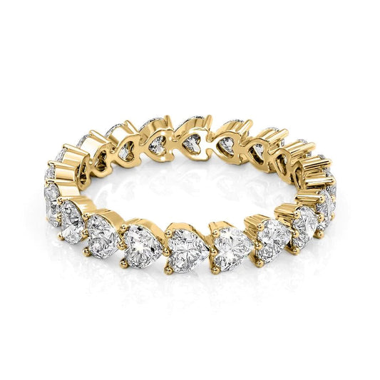 2.5ct Heart Shared Prong Eternity. A Yellow Gold Eternity Ring Set With 2.5tcw Heart Lab Grown Diamonds. White Background.