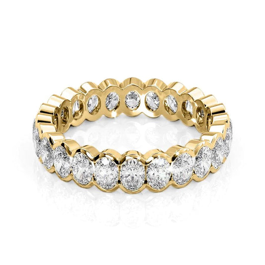 2ct Oval Half Bezel Eternity. A Yellow Gold Eternity Ring Set With 2tcw Oval Lab Grown Diamonds. White Background.