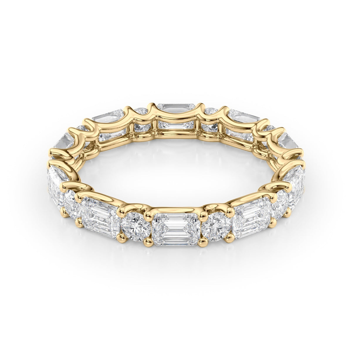3.2ct Alternating Emerald And Round U Prong Eternity. A Yellow Gold Eternity Ring Set With 2.5tcw Emerald Lab Grown Diamonds. White Background.