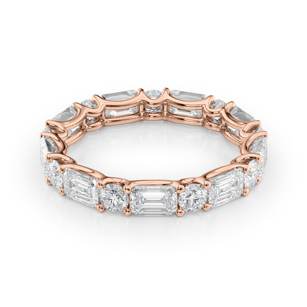 3.5ct Alternating Emerald And Round U Prong Eternity. A Rose Gold Eternity Ring Set With 2.7tcw Emerald Lab Grown Diamonds. White Background.