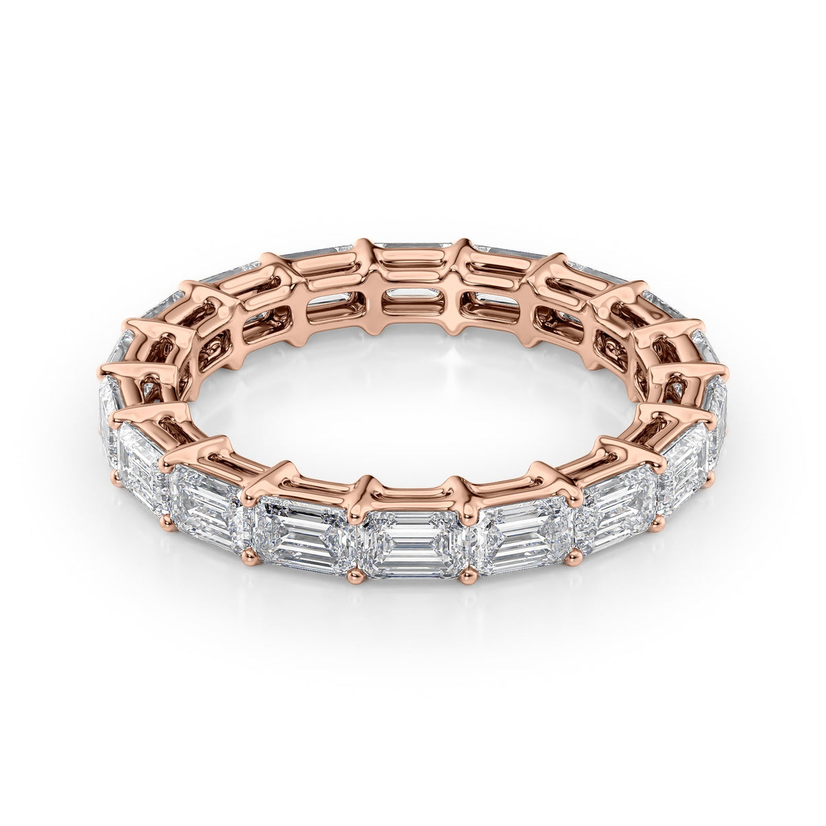 3.5ct East West Emerald Eternity. A Rose Gold Eternity Ring Set With 3.5tcw Emerald Lab Grown Diamonds. White Background.