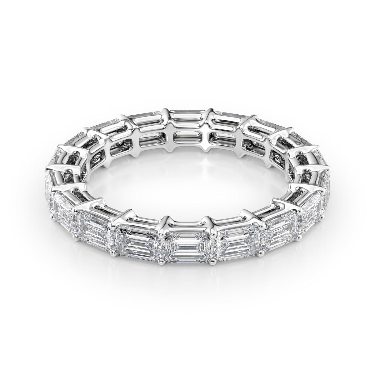 3.5ct East West Emerald Eternity. A White Gold Eternity Ring Set With 3.5tcw Emerald Lab Grown Diamonds. White Background.