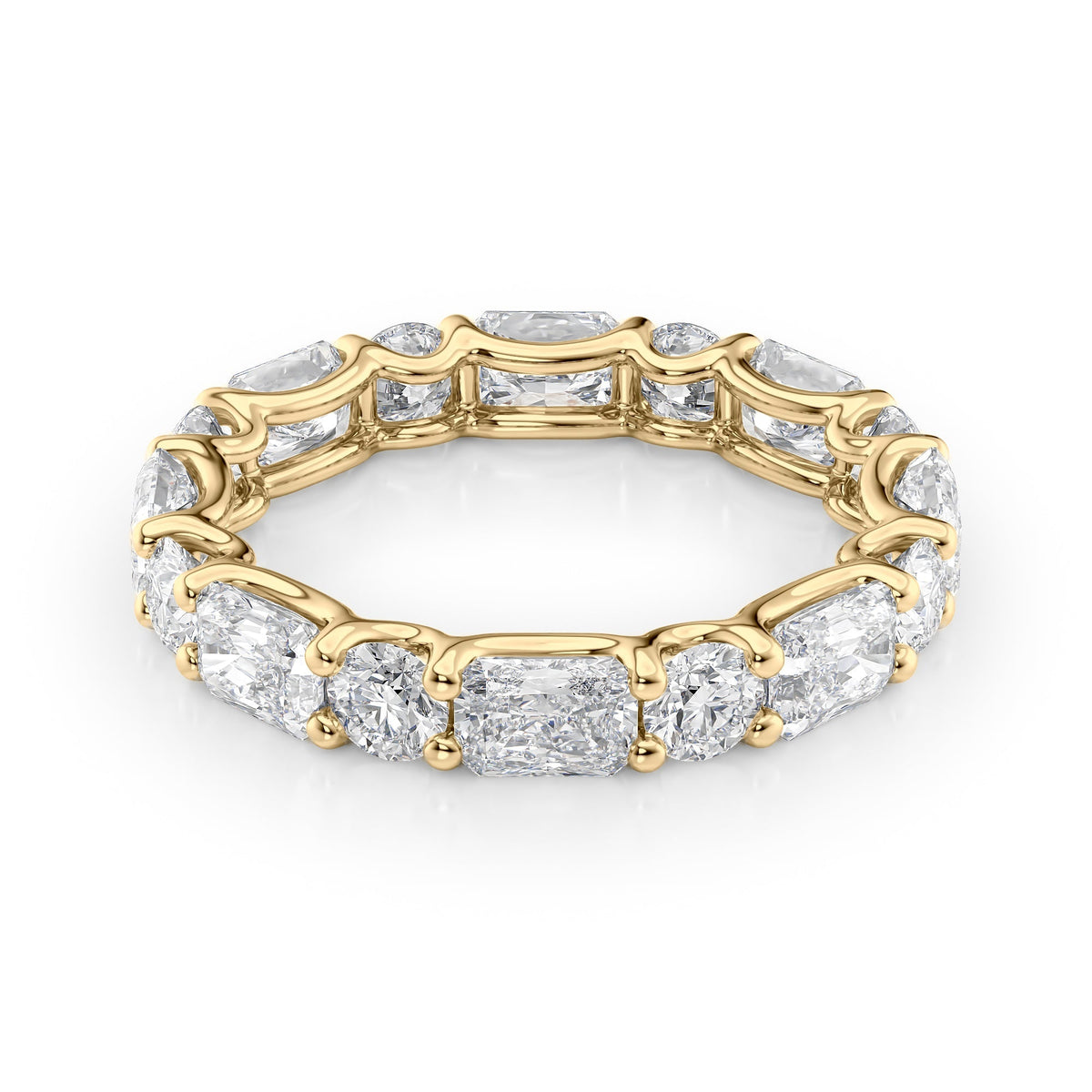 3.7ct Alternating Radiant And Round U Prong Eternity. A Yellow Gold Eternity Ring Set With 2.7tcw Radiant Lab Grown Diamonds. White Background.