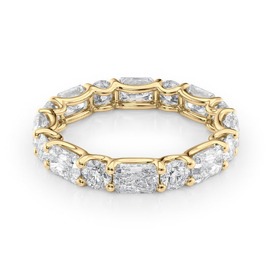 3.7ct Alternating Radiant And Round U Prong Eternity. A Yellow Gold Eternity Ring Set With 2.7tcw Radiant Lab Grown Diamonds. White Background.