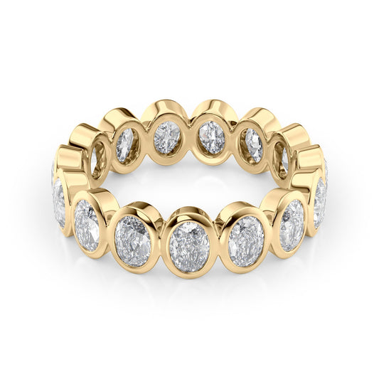 3ct Oval Bezel Eternity. A Yellow Gold Eternity Ring Set With 3tcw Oval Lab Grown Diamonds. White Background.