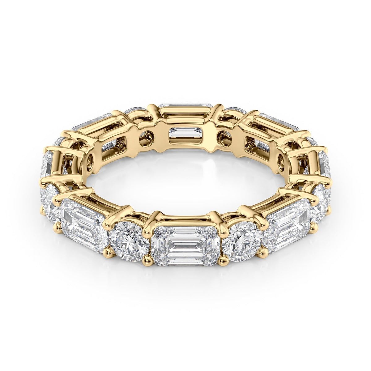 4.4ct Alternating Emerald And Round Basket Eternity. A Yellow Gold Eternity Ring Set With 3.3tcw Emerald Lab Grown Diamonds. White Background.