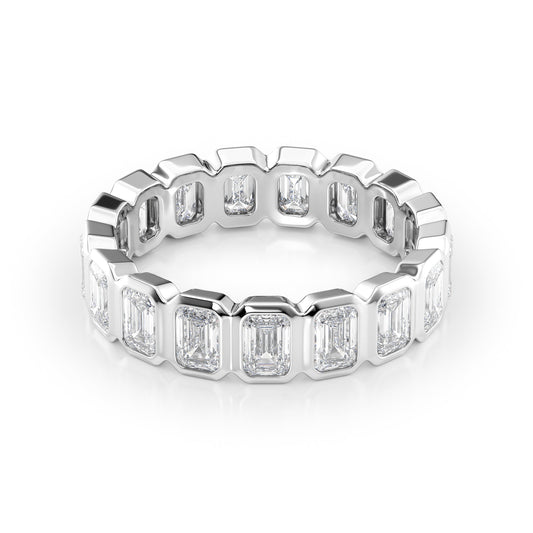 4.5ct Emerald Bezel Eternity. A White Gold Eternity Ring Set With 4.5tcw Emerald Lab Grown Diamonds. White Background.