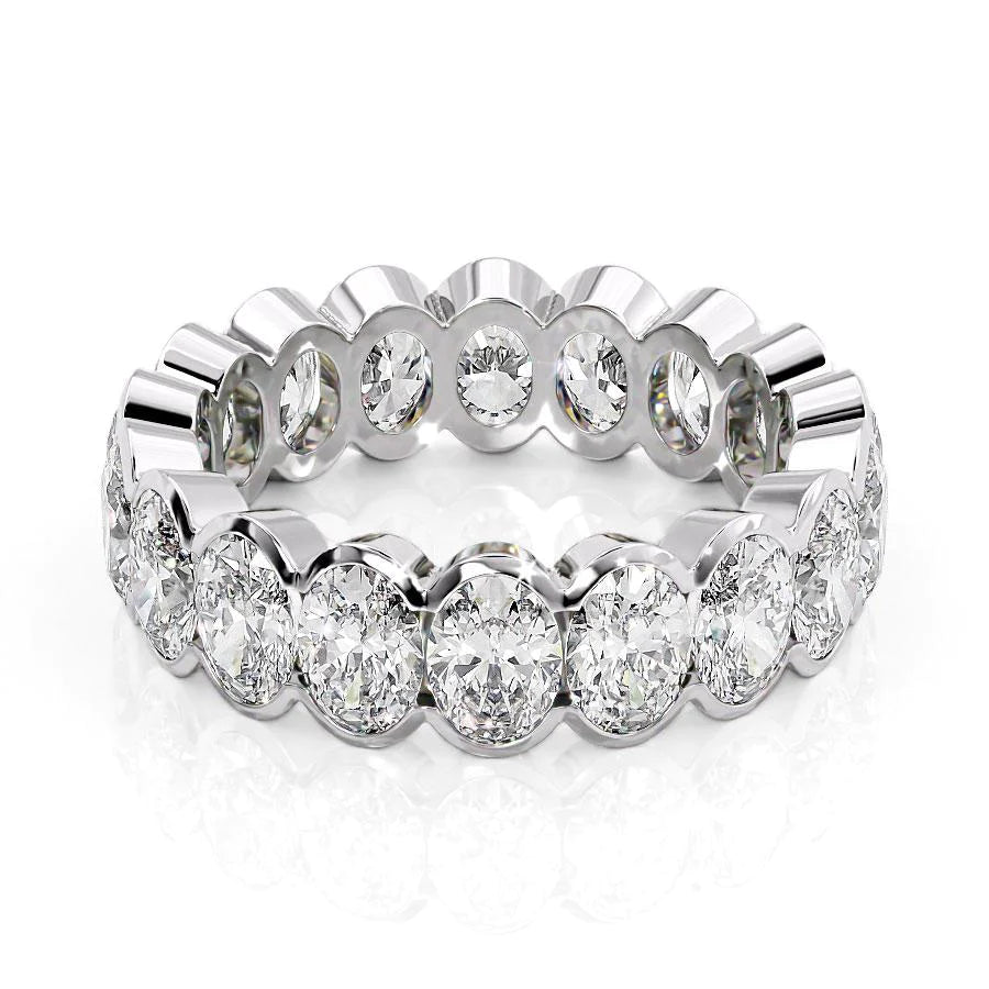 4.5ct Oval Half Bezel Eternity. A White Gold Eternity Ring Set With 4.5tcw Oval Lab Grown Diamonds. White Background.