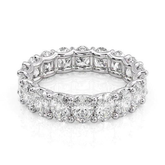 4.5ct Oval U Prong Eternity. A White Gold Eternity Ring Set With 4.5tcw Oval Lab Grown Diamonds. White Background.