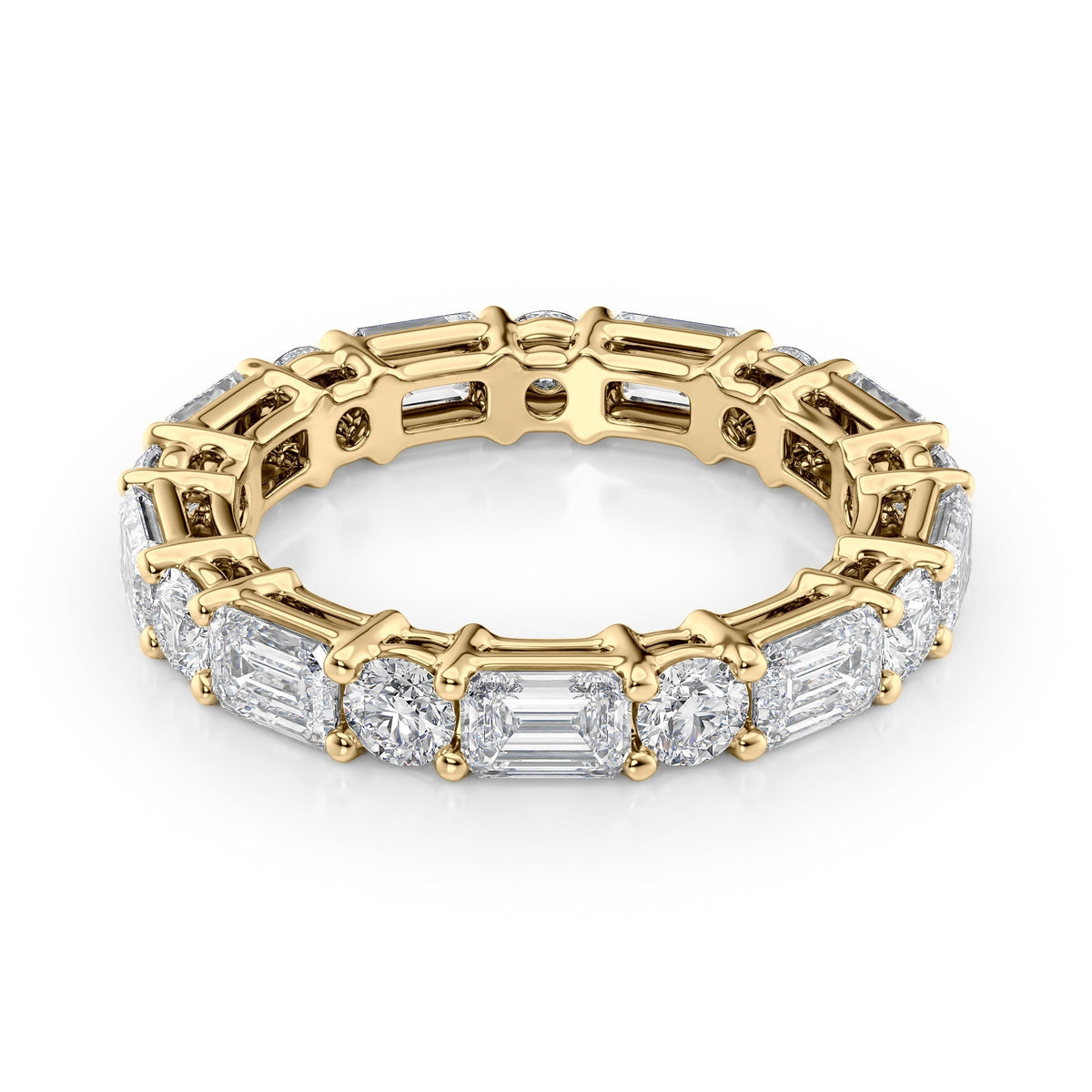 4ct Alternating Emerald And Round Basket Eternity. A Yellow Gold Eternity Ring Set With 3tcw Emerald Lab Grown Diamonds. White Background.