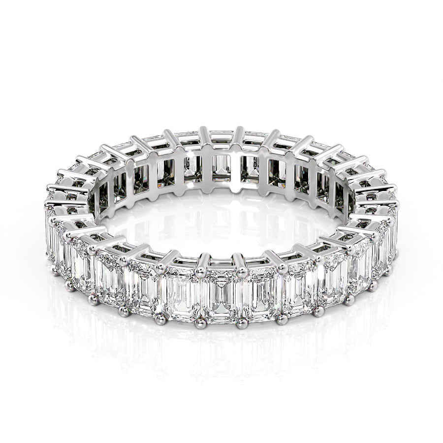 4ct Emerald Eternity. A White Gold Eternity Ring Set With 4tcw Emerald Lab Grown Diamonds. White Background.