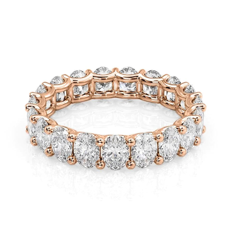 4ct Oval U Prong Eternity. A Rose Gold Eternity Ring Set With 4tcw Oval Lab Grown Diamonds. White Background.
