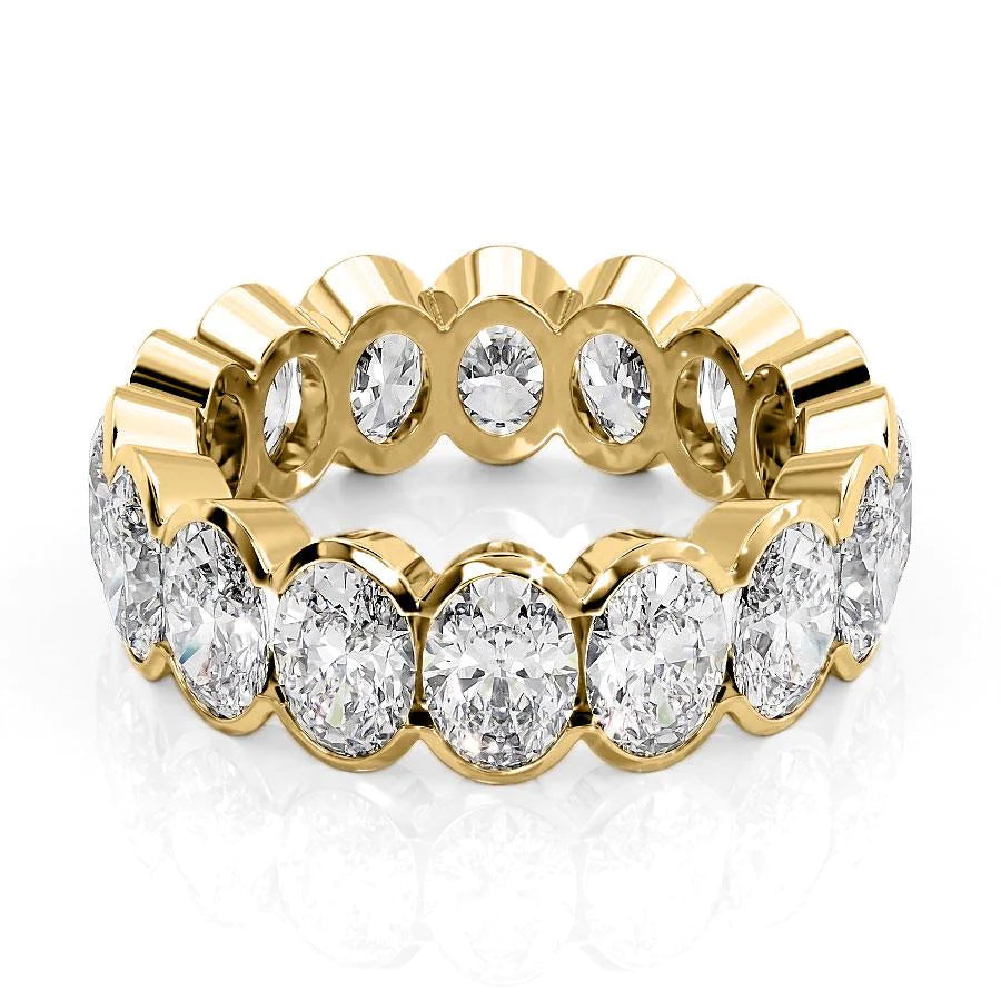 6.5ct Oval Half Bezel Eternity. A Yellow Gold Eternity Ring Set With 6.5tcw Oval Lab Grown Diamonds. White Background.