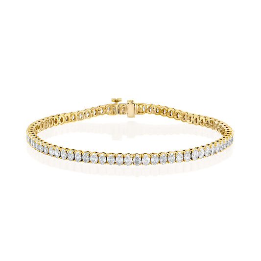 6ct Oval Tennis Bracelet. A Yellow Gold Tennis Bracelet Set With 6tcw Oval Lab Grown Diamonds. White Background.