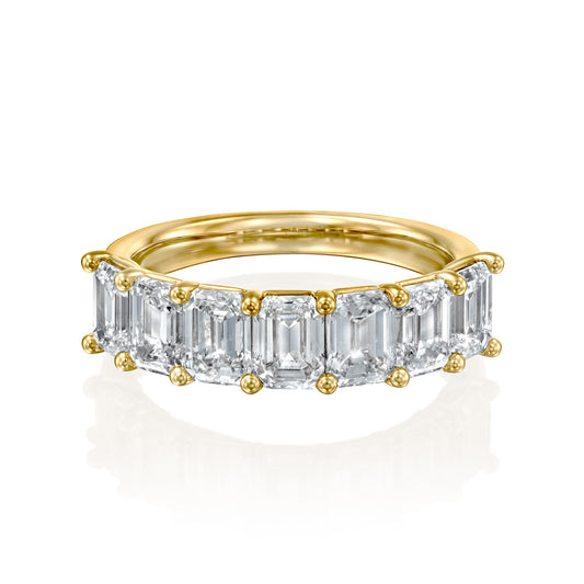 7 Stone 3ct Emerald Anniversary. A Yellow Gold Anniversary Ring Set With 3tcw Emerald Lab Grown Diamonds. White Background.