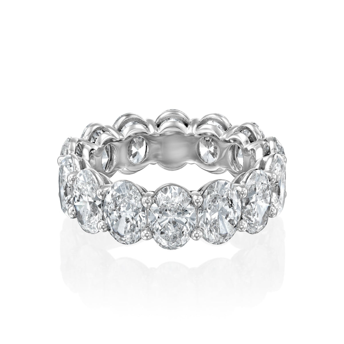7ct Oval Eternity. A White Gold Eternity Ring Set With 7tcw Oval Lab Grown Diamonds. White Background.