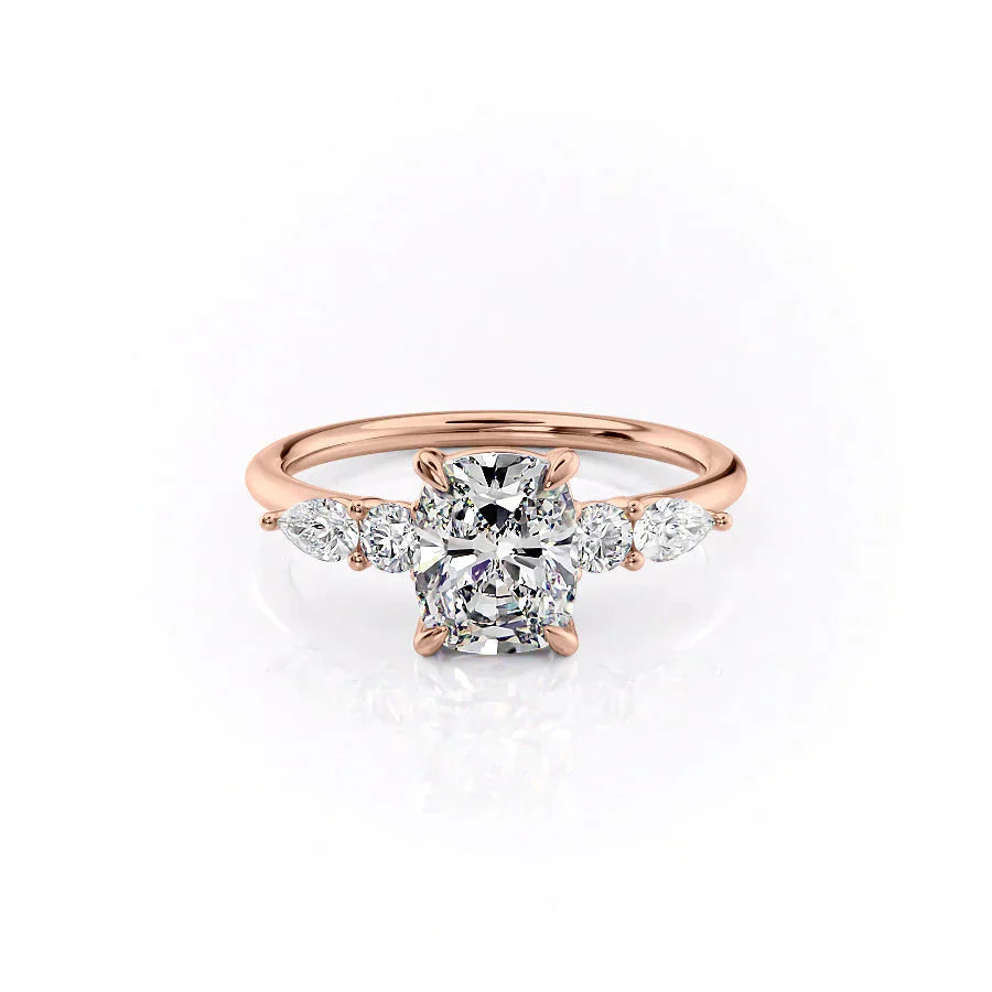 The Abigail. A Rose Gold Three Stone, Side Stones Engagement Ring Set With A 2ct Elongated Cushion Lab Grown Diamond. White Background.