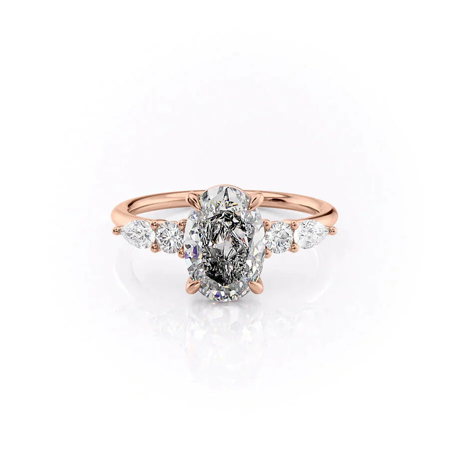 The Abigail. A Rose Gold Three Stone, Side Stones Engagement Ring Set With A 2ct Oval Lab Grown Diamond. White Background.