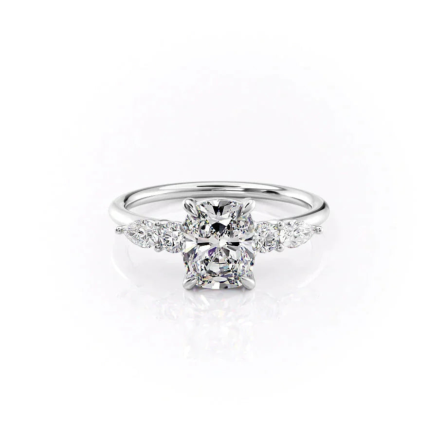 The Abigail. A White Gold Three Stone, Side Stones Engagement Ring Set With A 2ct Elongated Cushion Lab Grown Diamond. White Background.