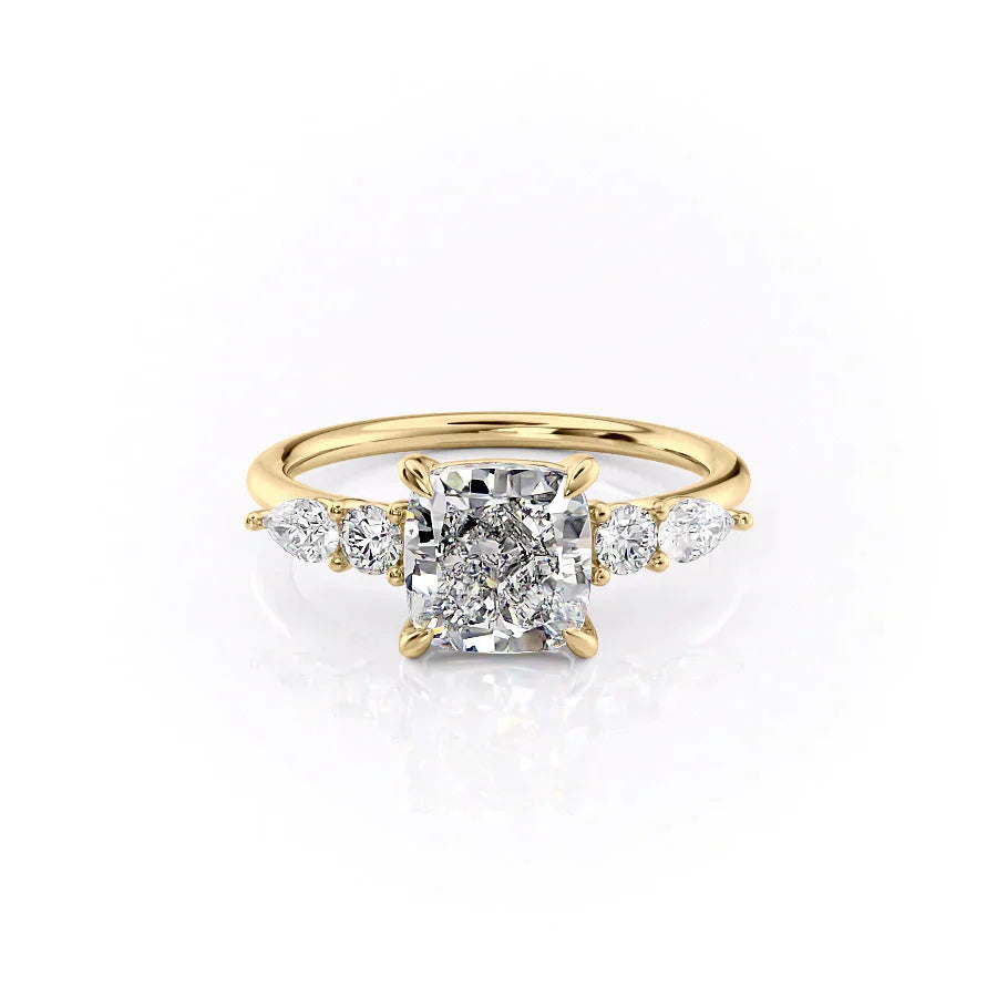 The Abigail. A Yellow Gold Three Stone, Side Stones Engagement Ring Set With A 2ct Cushion Lab Grown Diamond. White Background.