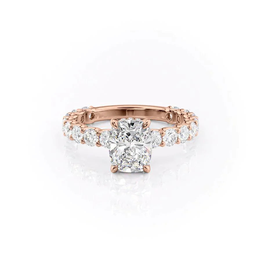 The Adelle. A Rose Gold Side Stones, Hidden Halo Engagement Ring Set With A 2ct Elongated Cushion Lab Grown Diamond. White Background.