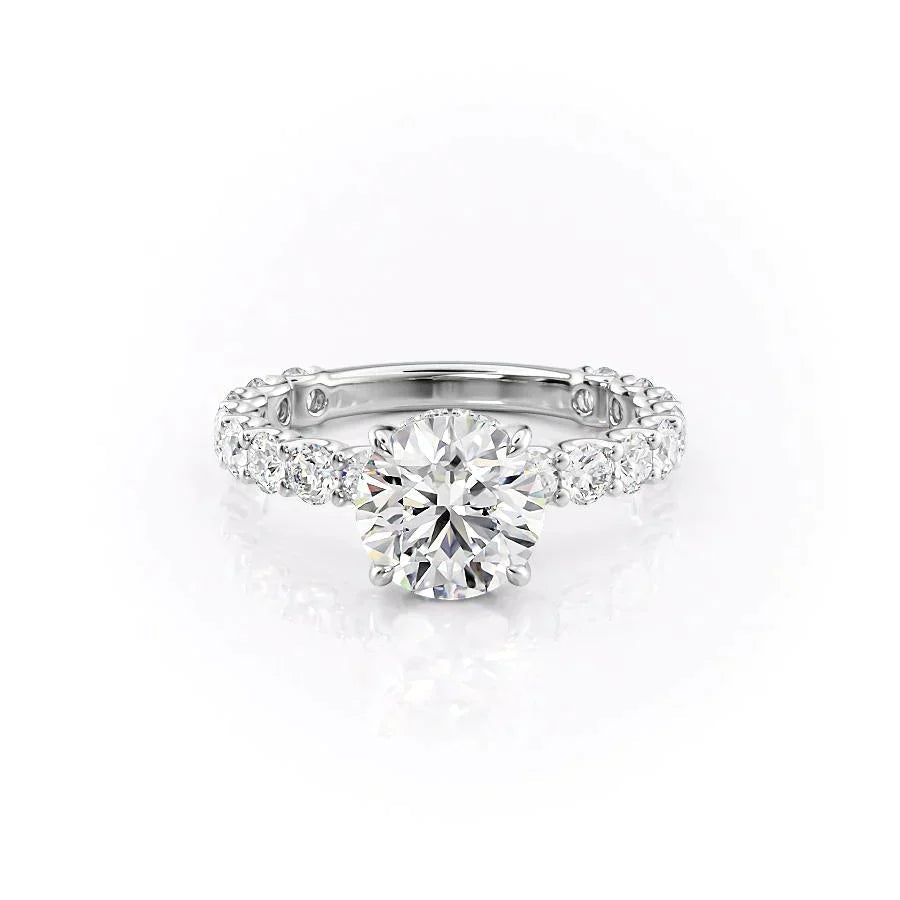 The Adelle. A White Gold Side Stones, Hidden Halo Engagement Ring Set With A 2ct Round Lab Grown Diamond. White Background.