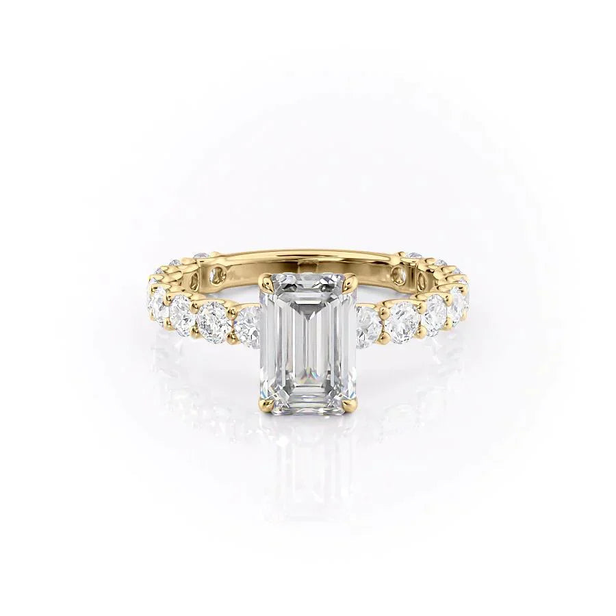 The Adelle. A Yellow Gold Side Stones, Hidden Halo Engagement Ring Set With A 2ct Emerald Lab Grown Diamond. White Background.