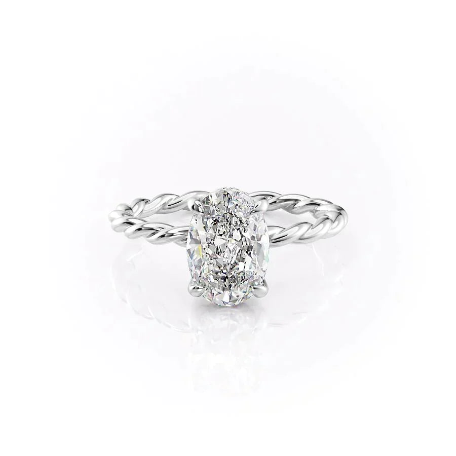 The Alice. A White Gold Solitaire, Hidden Halo Engagement Ring Set With A 2ct Oval Lab Grown Diamond. White Background.