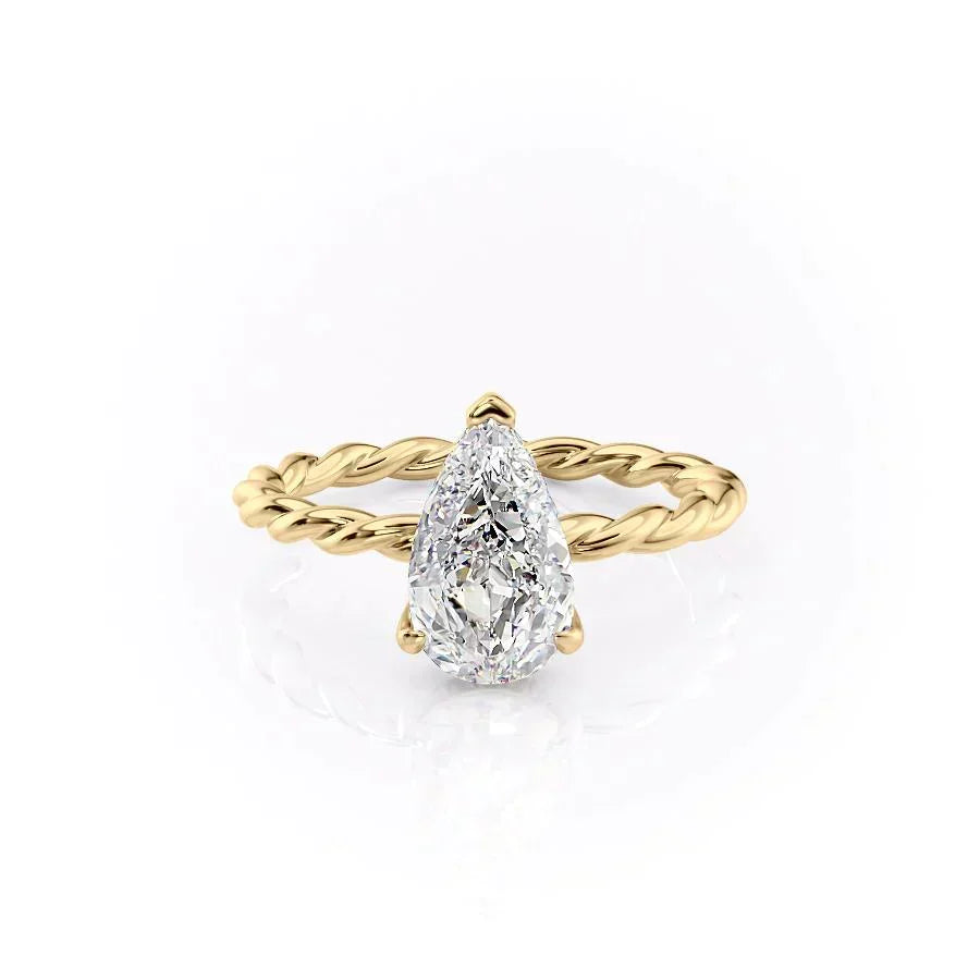 The Alice. A Yellow Gold Solitaire, Hidden Halo Engagement Ring Set With A 2ct Pear Lab Grown Diamond. White Background.