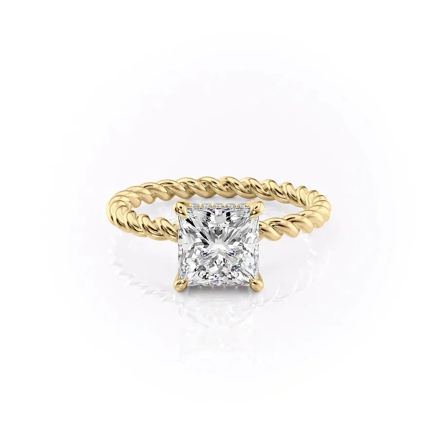 The Alice. A Yellow Gold Solitaire, Hidden Halo Engagement Ring Set With A 2ct Princess Lab Grown Diamond. White Background.