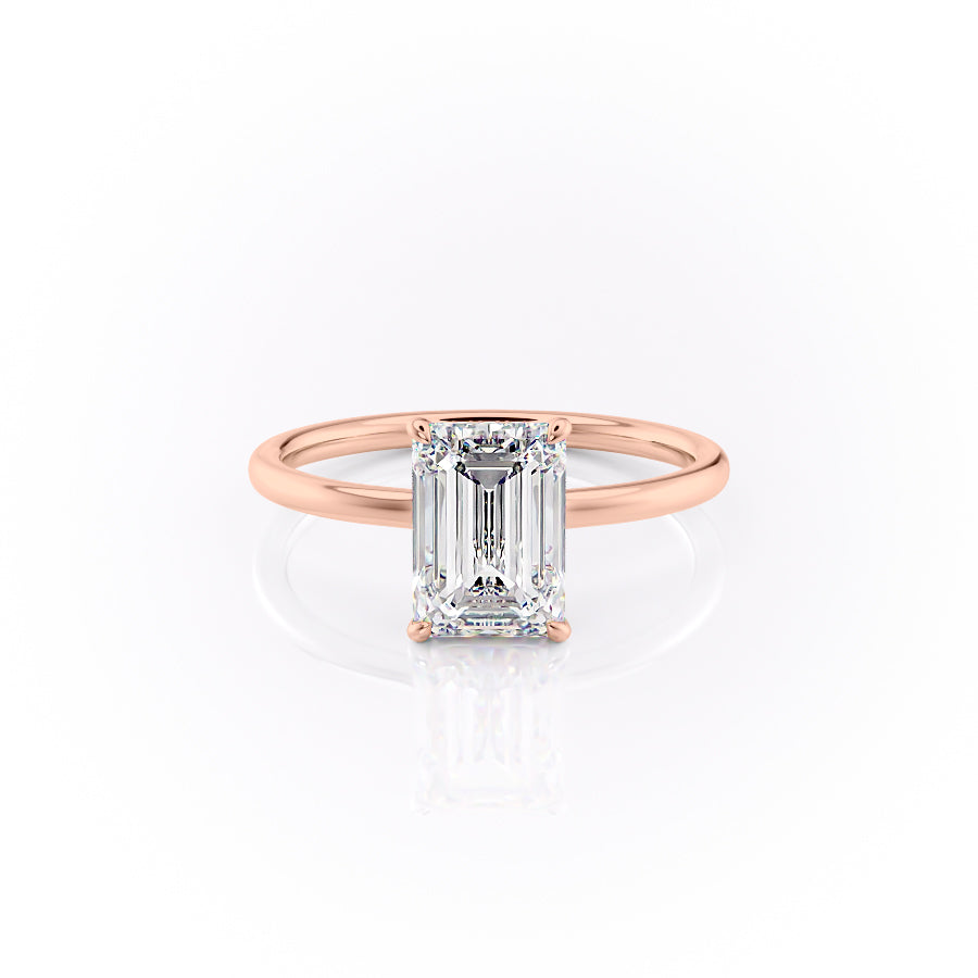 The Aline. A Rose Gold Solitaire, Hidden Halo Engagement Ring Set With A 2ct Emerald Lab Grown Diamond. White Background.