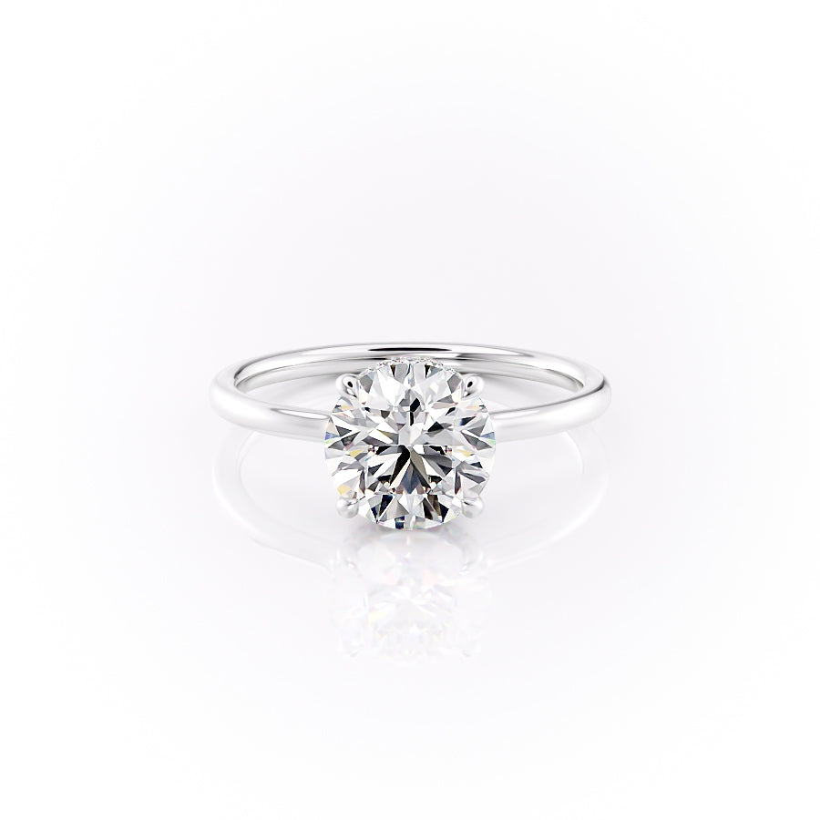 The Aline. A White Gold Solitaire, Hidden Halo Engagement Ring Set With A 2ct Round Lab Grown Diamond. White Background.
