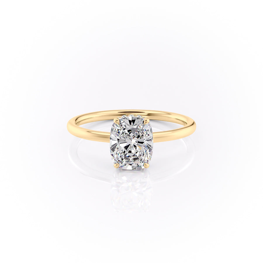 The Aline. A Yellow Gold Solitaire, Hidden Halo Engagement Ring Set With A 2ct Elongated Cushion Lab Grown Diamond. White Background.