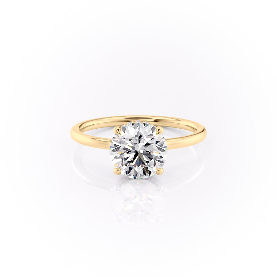 The Aline. A Yellow Gold Solitaire, Hidden Halo Engagement Ring Set With A 2ct Round Lab Grown Diamond. White Background.