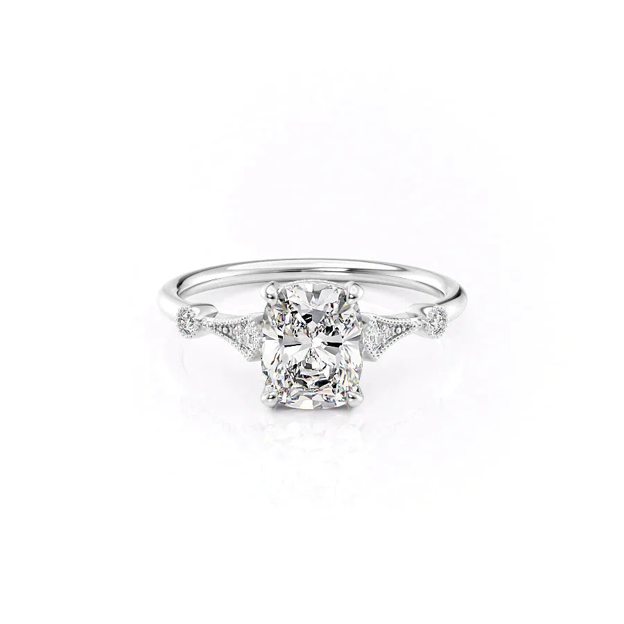 The Amber. A White Gold Vintage, Side Stones Engagement Ring Set With A 2ct Elongated Cushion Lab Grown Diamond. White Background.
