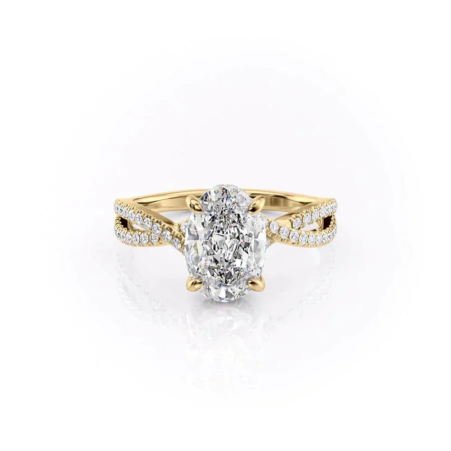 The Angelina. A Yellow Gold Pave, Hidden Halo Engagement Ring Set With A 2ct Oval Lab Grown Diamond. White Background.