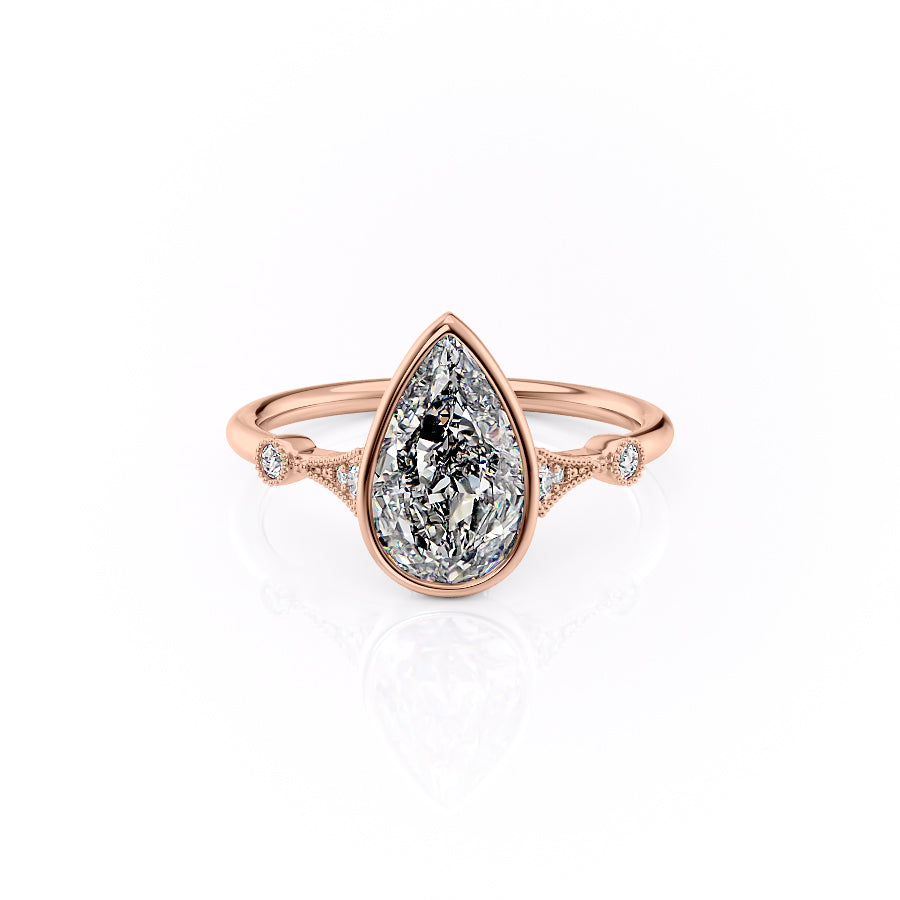 The Bezel Amber. A Rose Gold Vintage, Side Stones Engagement Ring Set With A 2ct Pear Lab Grown Diamond. White Background.