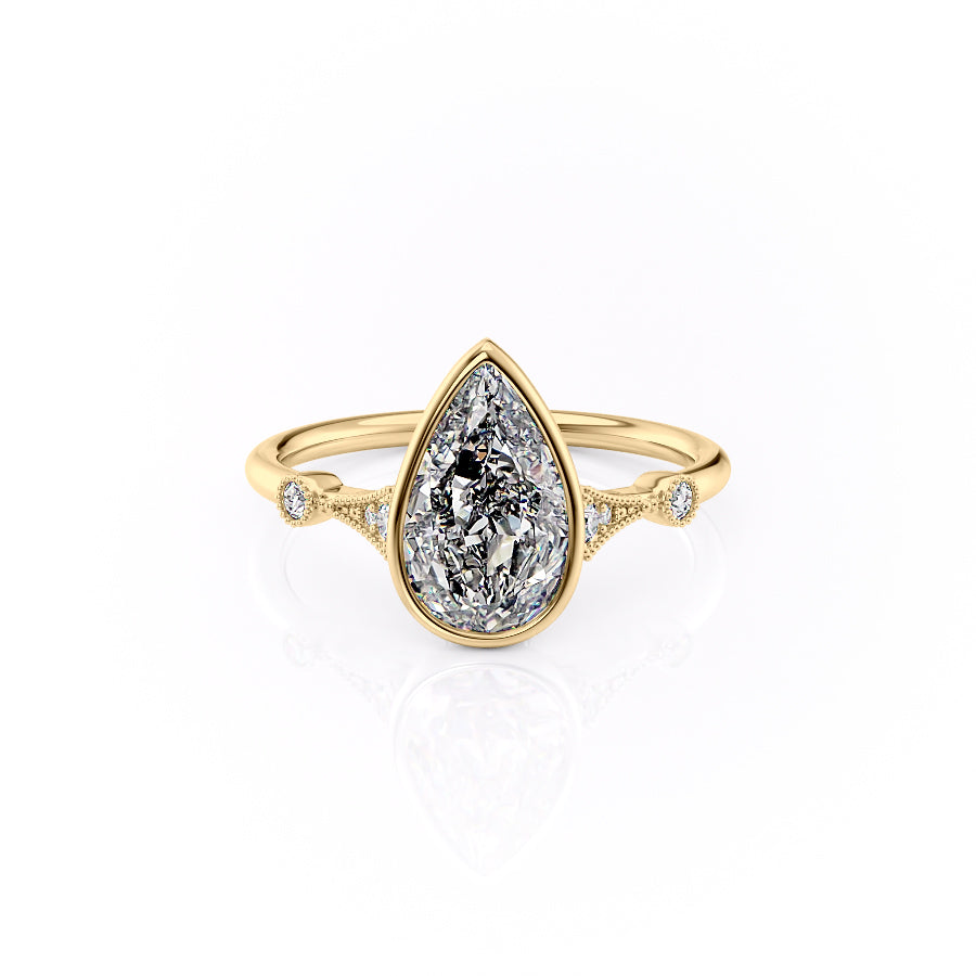 The Bezel Amber. A Yellow Gold Vintage, Side Stones Engagement Ring Set With A 2ct Pear Lab Grown Diamond. White Background.