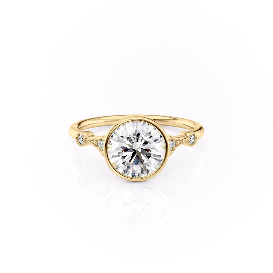 The Bezel Amber. A Yellow Gold Vintage, Side Stones Engagement Ring Set With A 2ct Round Lab Grown Diamond. White Background.